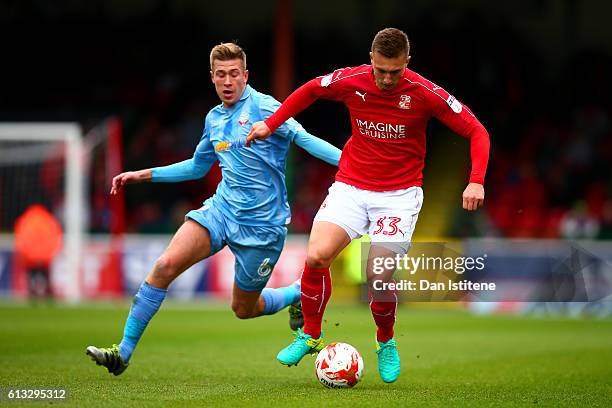 Luke Norris of Swindon Town battles for the ball with Josh Vela of Bolton Wanderers during the Sky Bet League One match between Swindon Town and...