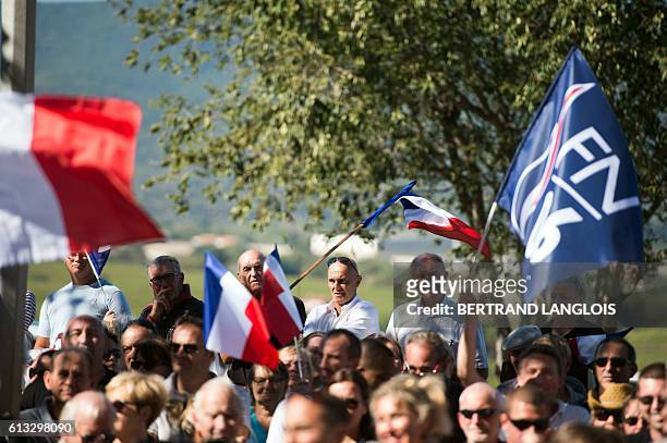 French far-right Front National 's supporters wave French national flag as they take part in a rally against the possibilty of welcoming refugees in...