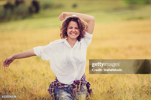 girl enjoying nature on the field - girl short hair stock pictures, royalty-free photos & images