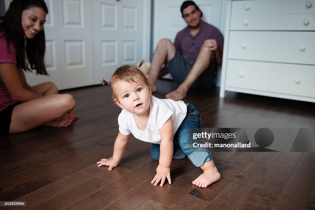 Baby girl is walking with the help of the hands