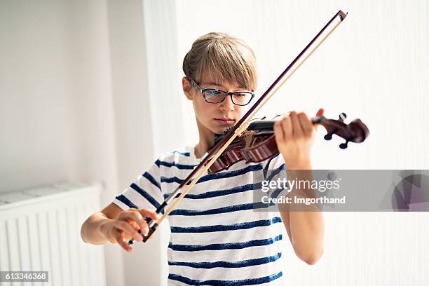 teenage girl playing violin at home - young violinist stock pictures, royalty-free photos & images