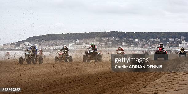 Riders race down the beach during the Adult Quad and Sidecar race at the 2016 HydroGarden Weston Beach Race in Weston-super-Mare, south west England,...