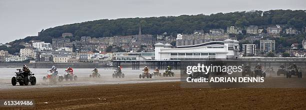 Riders race down the beach during the Adult Quad and Sidecar race at the 2016 HydroGarden Weston Beach Race in Weston-super-Mare, south west England,...