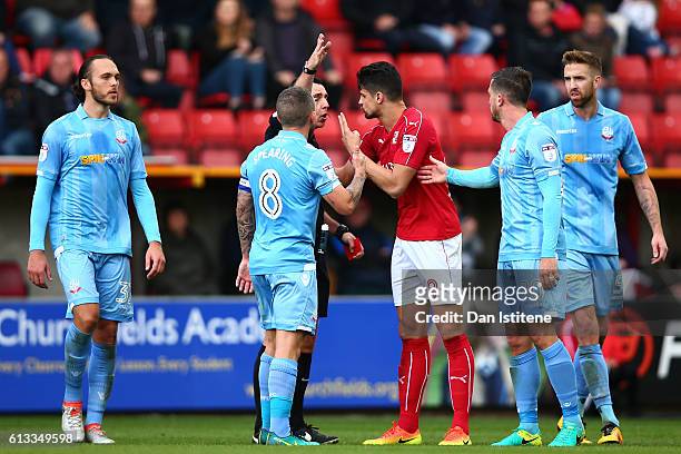 Raphael Rossi Branco of Swindon Town argues with referee Neil Swarbrick after being sent off during the Sky Bet League One match between Swindon Town...