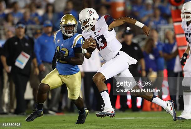 Anu Solomon of the Arizona Wildcats runs past Jayon Brown of the UCLA Bruins during the first half of a game at the Rose Bowl on October 1, 2016 in...