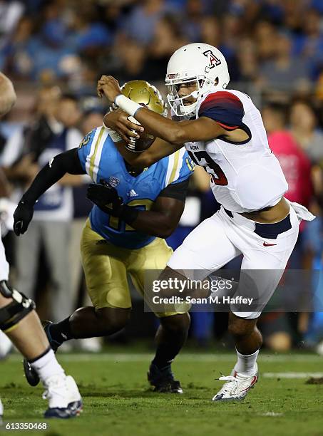 Anu Solomon of the Arizona Wildcats runs past Jayon Brown of the UCLA Bruins during the first half of a game at the Rose Bowl on October 1, 2016 in...