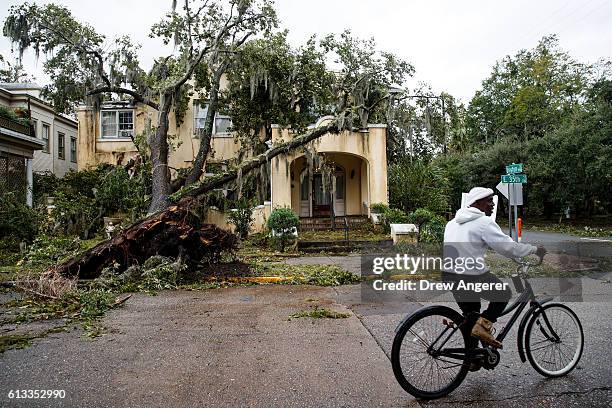 Downed tree from Hurricane Matthew rests against a home, October 8, 2016 in Savannah, Georgia. Across the Southeast, Over 1.4 million people have...