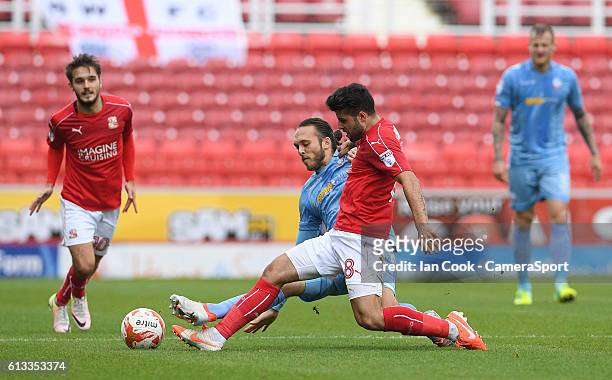 Bolton Wanderers Tom Thorpe battles with Swindon Town's Yaser Kasim during the Sky Bet League One match between Swindon Town and Bolton Wanderers at...