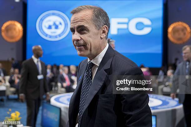 Mark Carney, governor of the Bank of England, speaks to an attendee during an International Monetary Fund Committee governors plenary session at the...