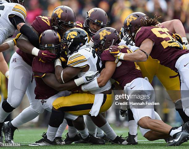 LeShun Daniels Jr. #29 of Iowa is tackled by Minnesota during the second quarter of the game on October 8, 2016 at TCF Bank Stadium in Minneapolis,...