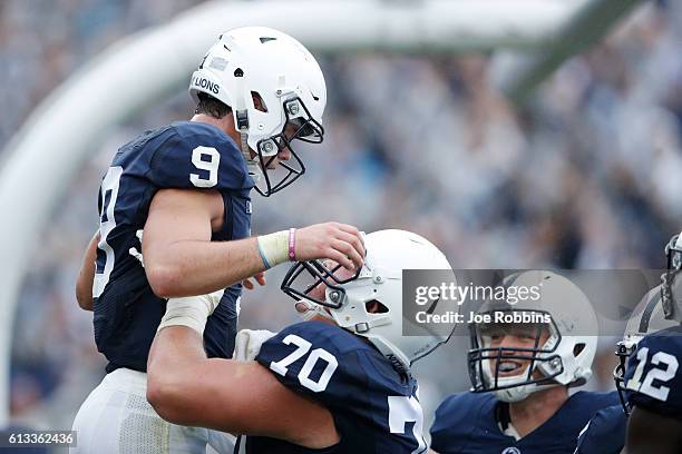 Trace McSorley of the Penn State Nittany Lions is lifted up by Brendan Mahon after rushing for a nine-yard touchdown in the second quarter against...