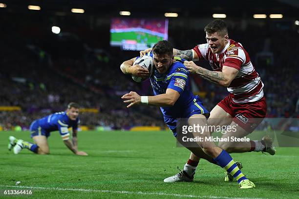 Declan Patton of Warrington scores the opening try despite the challenge from John Bateman of Wigan during the First Utility Super League Final...