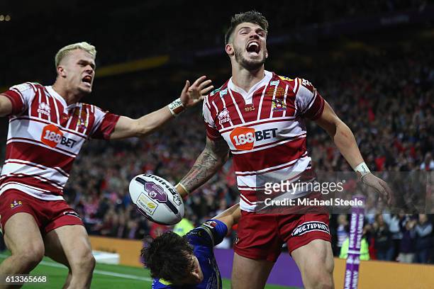 Oliver Gildart of Wigan celebrates scoring his sides opening try alongside Lewis Tierney during the First Utility Super League Final between...