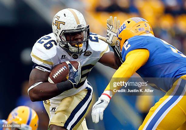 Dedrick Mills of the Georgia Tech Yellow Jackets rushes in the first half during the game against Terrish Webb of the Pittsburgh Panthers on October...