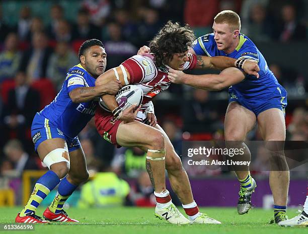 Anthony Gelling of Wigan Warriors is tackled by Jack Hughes of Warrington Wolves during the First Utility Super League Final between Warrington...