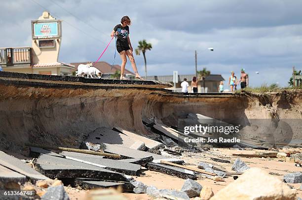 Brittany Durochar along part of A1A after ocean waters stirred up by Hurricane Matthew washed away parts of the ocean front road on October 8, 2016...
