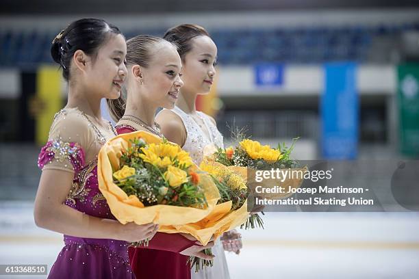 Yuna Shiraiwa of Japan, Anastasiia Gubanova of Russia and Eunsoo Lim of Korea pose during the Junior Ladies Medal Ceremony on day three of the ISU...