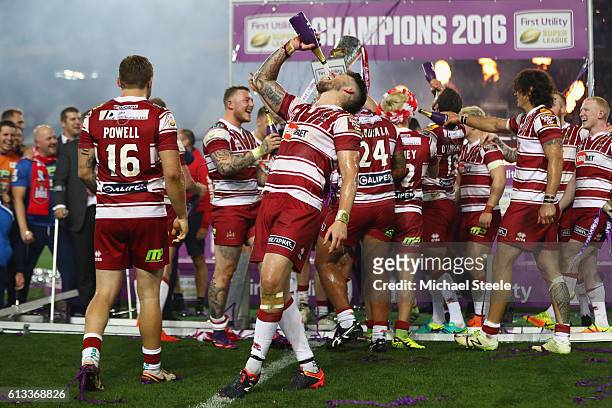 Oliver Gildart of Wigan celebrates his sides 12-6 victory with a bottle of champagne during the First Utility Super League Final between Warrington...