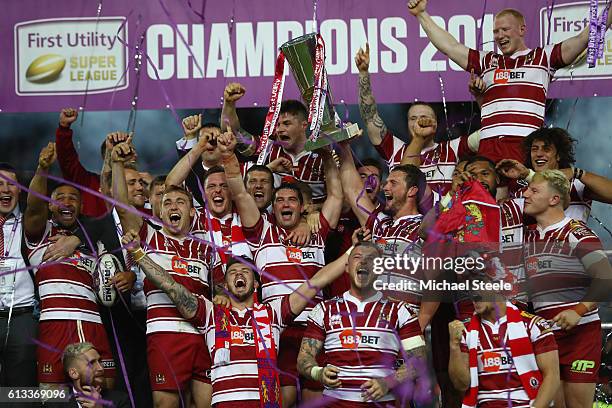 Sean O'Loughlin and Matty Smith of Wigan lift the winners trophy after their sides 12-6 victory during the First Utility Super League Final between...