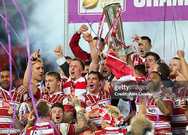 Matty Smith and Sean O'Loughlin of Wigan Warriors lift the First Utility Super League trophy aloft after victory over Warrington Wolves in the First...
