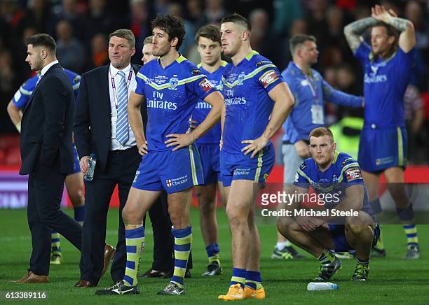Tony Smith the coach of Warrington looks on alongside dejected players after his sides 6-12 defeat during the First Utility Super League Final...