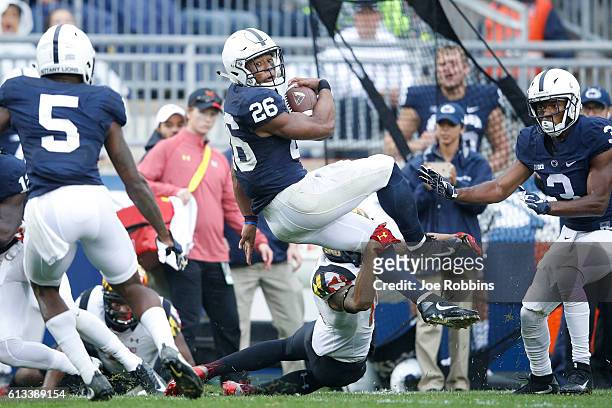 Saquon Barkley of the Penn State Nittany Lions runs with the ball against the Maryland Terrapins in the third quarter at Beaver Stadium on October 8,...