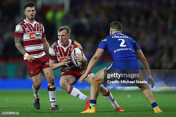 Dan Sarginson of Wigan sidesteps Tom Lineham of Warrington during the First Utility Super League Final between Warrington Wolves and Wigan Warriors...