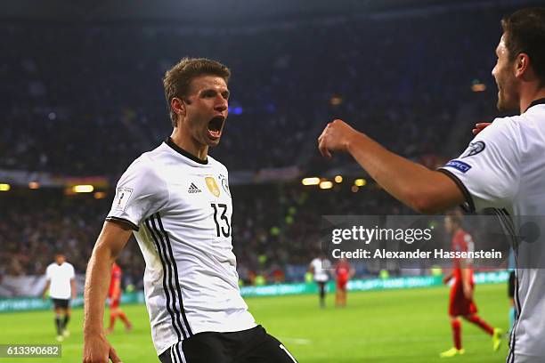 Thomas Mueller of Germany celebrates scoring the 3rd goal with his team mate Jonas Hector during the 2018 FIFA World Cup Qualifier match between...