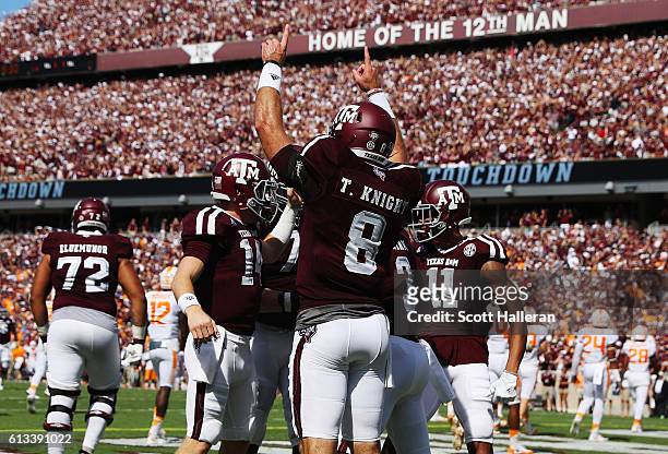 Trevor Knight of the Texas A&M Aggies celebrates with his teammates after throwing a touchdown pass in the first half of their game against the...