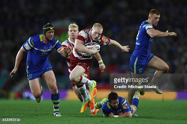 Liam Farrell of Wigan winner of the man of the match award breaks through the Warrington defence to set up his sides first try during the First...