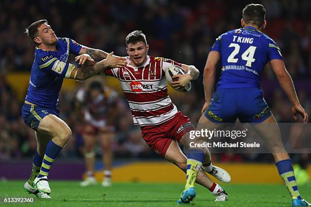 John Bateman of Wigan holds off the challenge from Daryl Clark of Warrington as Toby King closes in during the First Utility Super League Final...