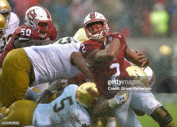 Jalan McClendon of the North Carolina State Wolfpack runs the wildcat as Nyles Morgan of the Notre Dame Fighting Irish defends during the game at...