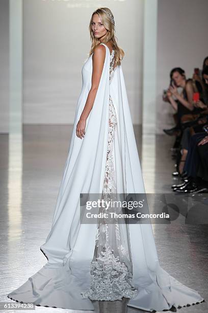 Model walks the runway wearing Pronovias Bridal at Prince George Ballroom on October 8, 2016 in New York City.