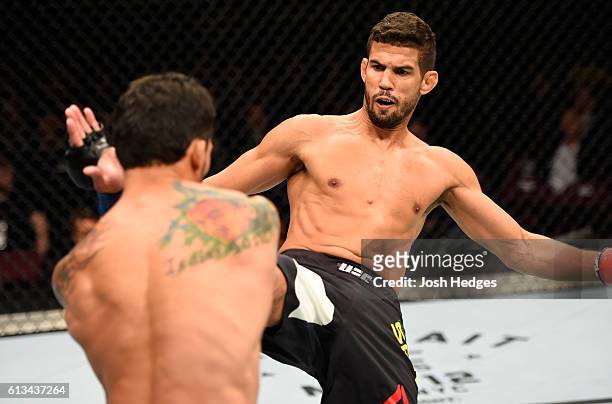 Leonardo Santos of Brazil kicks Adriano Martins of Brazil in their lightweight bout during the UFC 204 Fight Night at the Manchester Evening News...