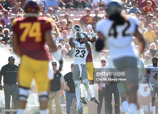 Darreus Rogers of the USC Trojans makes a catch over Ahkello Witherspoon of the Colorado Buffaloes for a first down during the fourth quarter at Los...