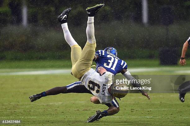 Breon Borders of the Duke Blue Devils upends John Trainor of the Army Black Knights at Wallace Wade Stadium on October 8, 2016 in Durham, North...