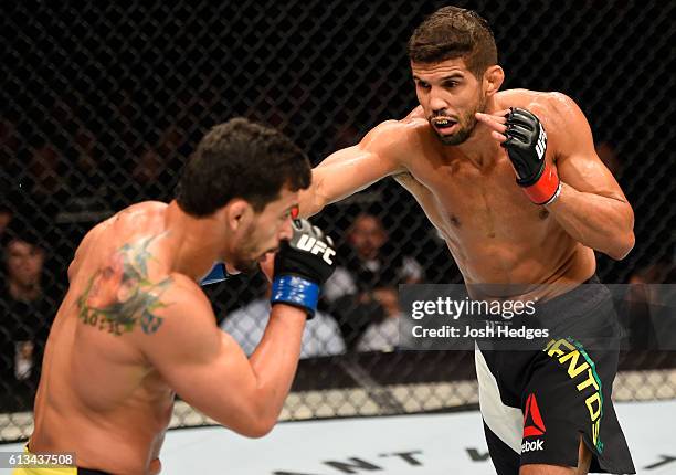 Leonardo Santos of Brazil punches Adriano Martins of Brazil in their lightweight bout during the UFC 204 Fight Night at the Manchester Evening News...