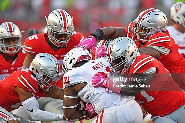 Tyler Natee of the Indiana Hoosiers is ganged up by the Ohio State Buckeyes defense in the fourth quarter for no gain at Ohio Stadium on October 8,...