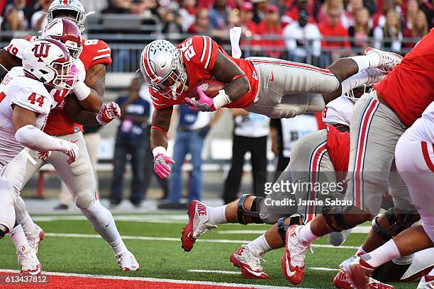 Mike Weber of the Ohio State Buckeyes leaps over the goal line for a one-yard touchdown run in the third quarter against the Indiana Hoosiers at Ohio...
