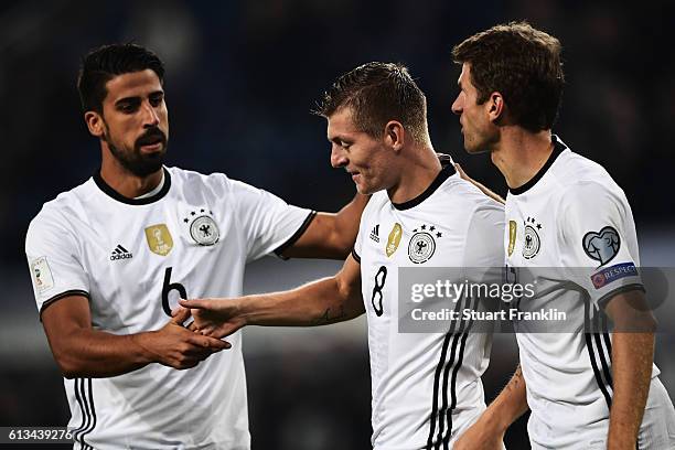 Toni Kroos of Germany celebrates scoring his goal with Thomas Mueller and Sami Khedira during the 2018 FIFA World Cup Qualifier match between Germany...