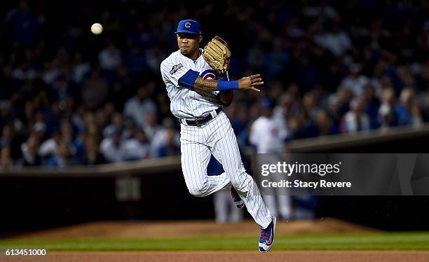 Addison Russell of the Chicago Cubs throws to first base in the eighth inning against the San Francisco Giants at Wrigley Field on October 8, 2016 in...