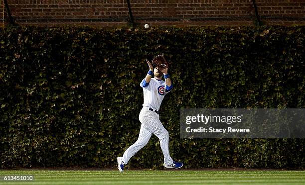 Ben Zobrist of the Chicago Cubs catches a fly ball in the seventh inning against the San Francisco Giants at Wrigley Field on October 8, 2016 in...