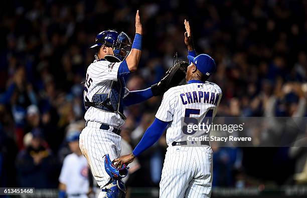 Willson Contreras and Aroldis Chapman of the Chicago Cubs celebrate after beating the San Francisco Giants 5-2 at Wrigley Field on October 8, 2016 in...