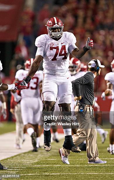 Cam Robinson of the Alabama Crimson Tide jumps for joy after a touchdown during a game against the Arkansas Razorbacks at Razorback Stadium on...