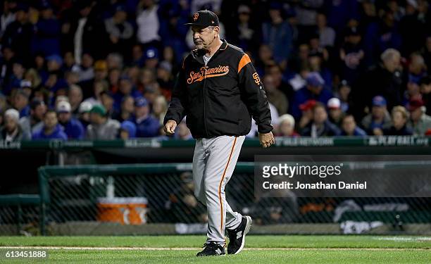 Manager Bruce Bochy of the San Francisco Giants walks to the mound in the seventh inning against the Chicago Cubs at Wrigley Field on October 8, 2016...