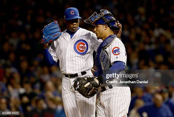 Aroldis Chapman and Willson Contreras of the Chicago Cubs celebrate after beating the San Francisco Giants 5-2 at Wrigley Field on October 8, 2016 in...