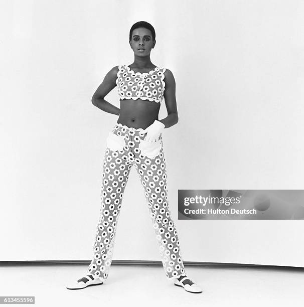 Model wears a sleeveless, cropped top and slim-fitting pants, designed by French fashion designer Jules-Francois Crahay for the Lanvin fashion house.