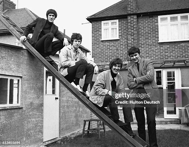 Members of the Spencer Davis Group : Muff Winwood, Steve Winwood, Spencer Davis and Pete York pose on a ladder outside Davis's house in Potter's Bar,...