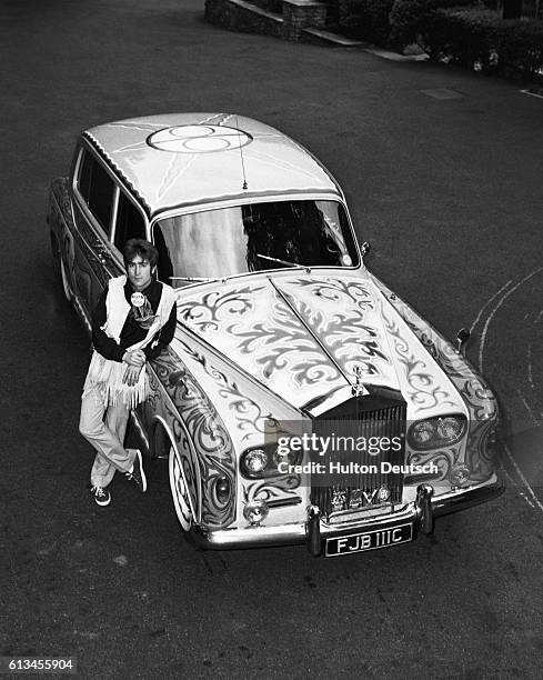 The Beatles star John Lennon shows off his psychedelic Rolls Royce, circa 1967.