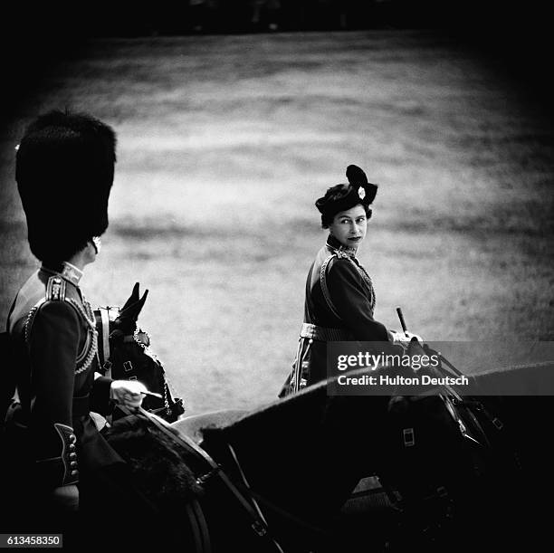 The Queen turns towards the Duke of Edinburgh during the 1961 Trooping the Colour ceremony to mark her 35th birthday.